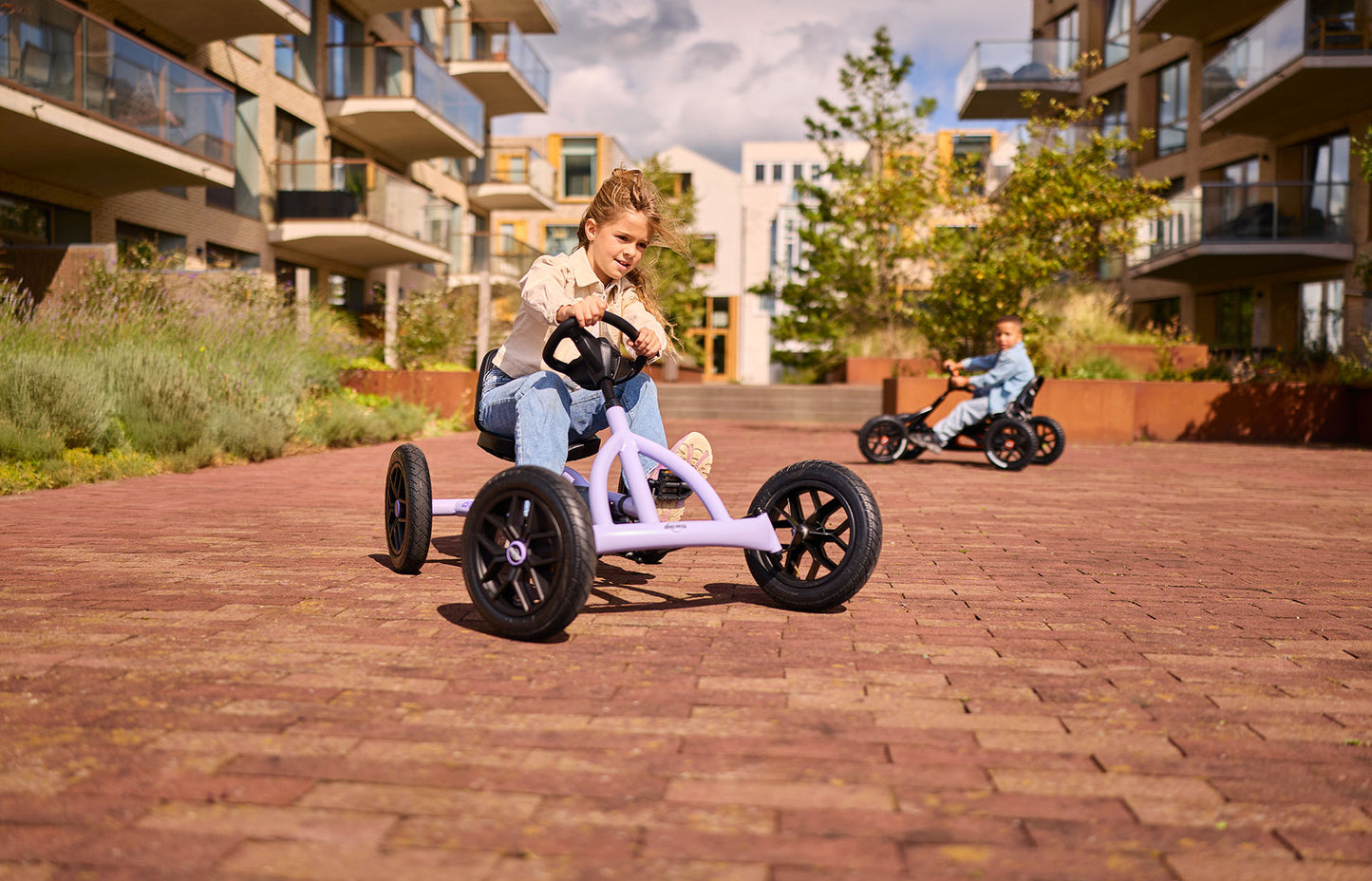 children enjoying outdoor play with BERG Buddy Purple pedal go kart fun active lifestyle