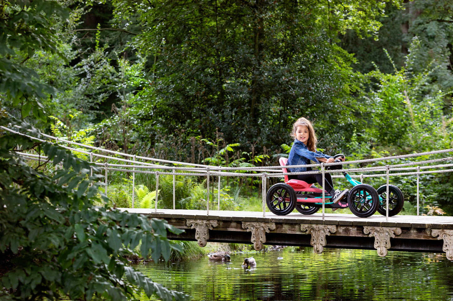 Child riding BERG Buddy Lua pedal go-kart outdoors