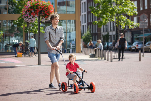 Child riding BERG Buzzy Nitro 2-in-1 go-kart outdoors