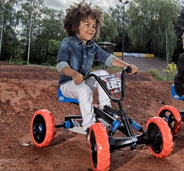 Child riding a BERG Buzzy Nitro pedal go-kart outdoors