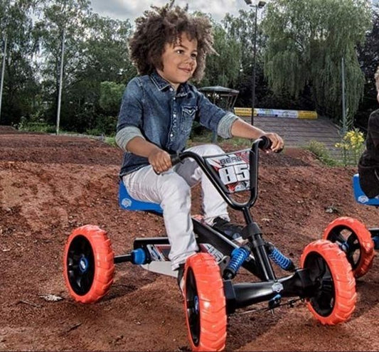 Child riding a BERG Buzzy Nitro pedal go-kart outdoors