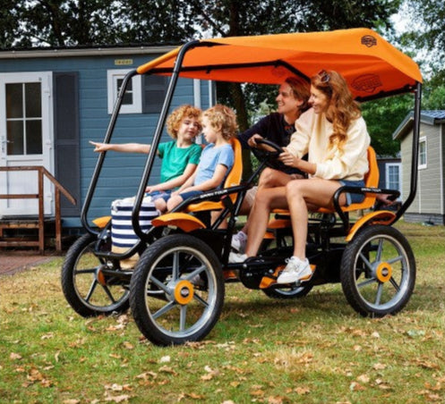 Child riding BERG Gran Tour pedal go-kart outdoors