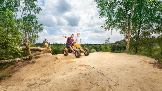 Child riding BERG X-Treme pedal go-kart outdoors