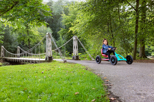 Child riding BERG Buddy Lua pedal go-kart outdoors