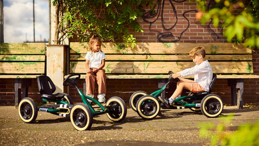 Child riding BERG Buddy Retro Green pedal go-kart outdoors
