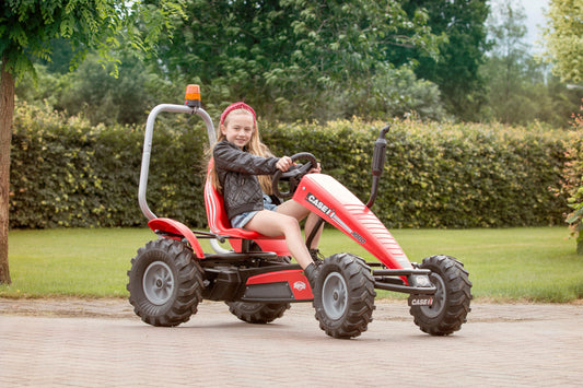 Child riding BERG Case Tractor pedal tractor outdoors