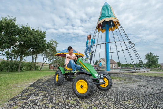Child riding BERG John Deere Tractor pedal tractor outdoors