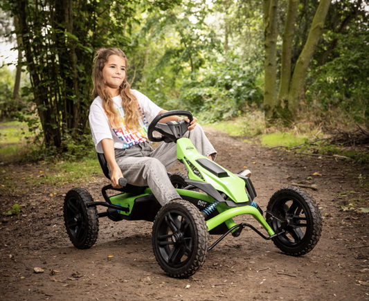 Child riding BERG Rally DRT Green pedal go-kart outdoors