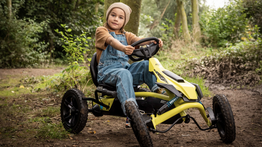Child riding BERG Rally DRT Yellow 3 Gear pedal go-kart outdoors