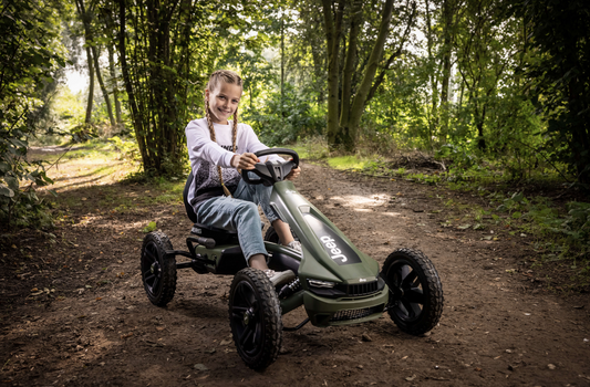 Child riding BERG Rally Jeep Cherokee pedal go-kart outdoors