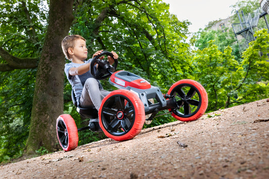 Child riding BERG Reppy Rebel pedal go-kart outdoors