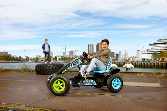 Child riding BERG X-ite pedal go-kart outdoors