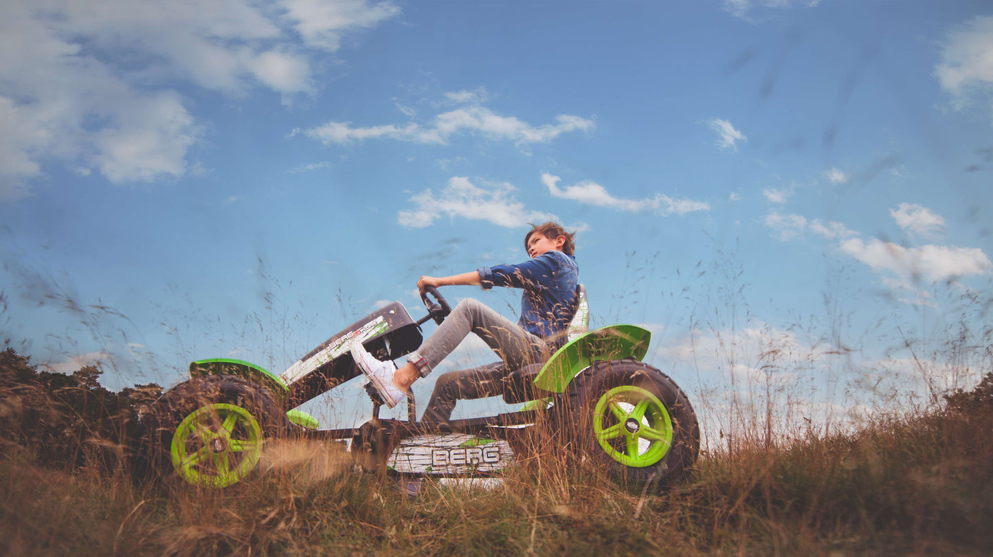 Child riding BERG X-Plore pedal go-kart outdoors