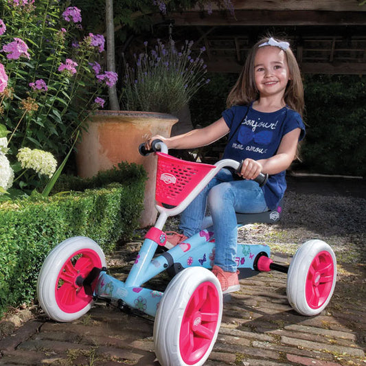 Child riding BERG Buzzy Bloom pedal go-kart outdoors