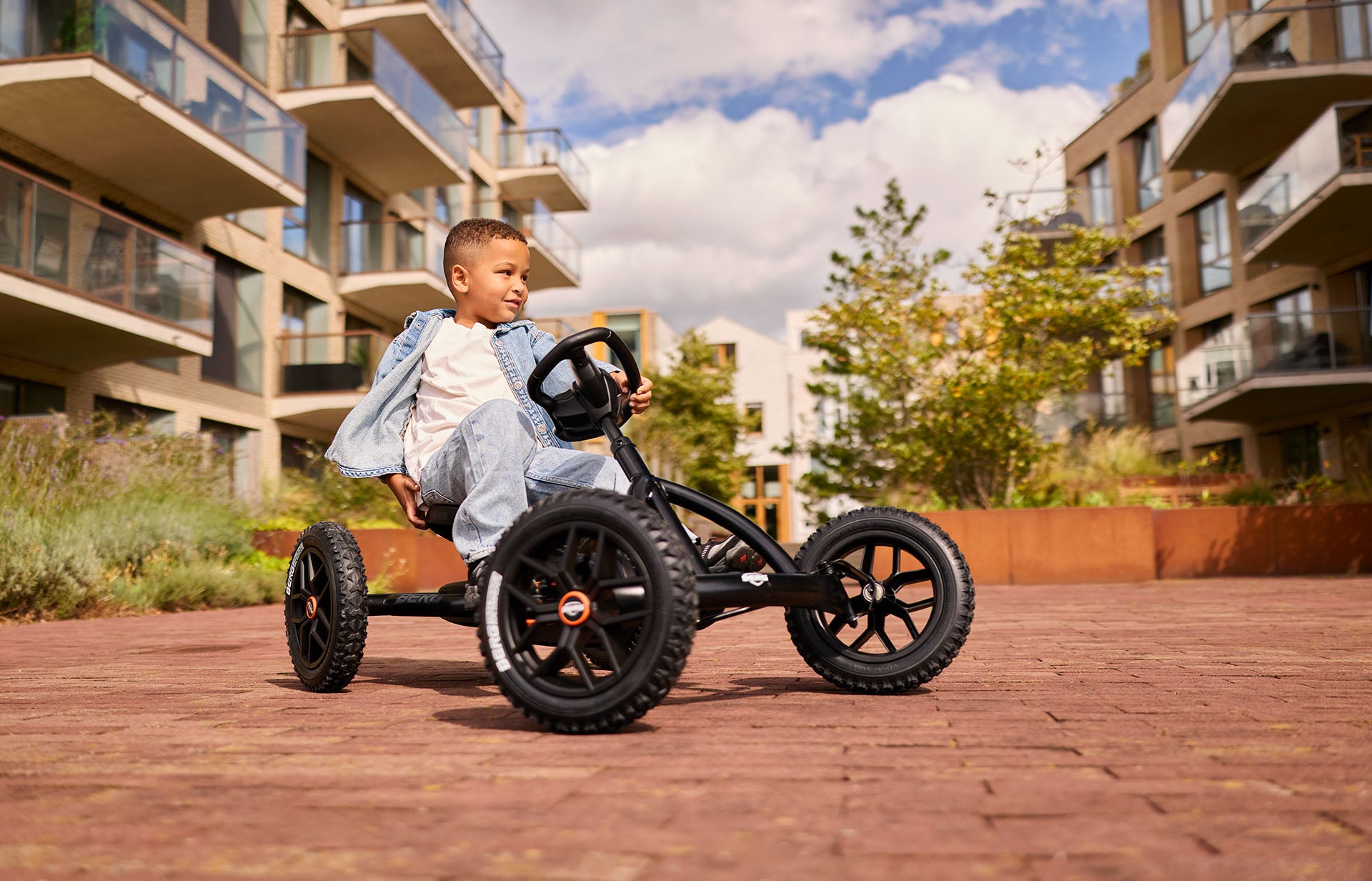 kids playing outside with BERG Buddy Cross Black go kart active outdoor play and fun