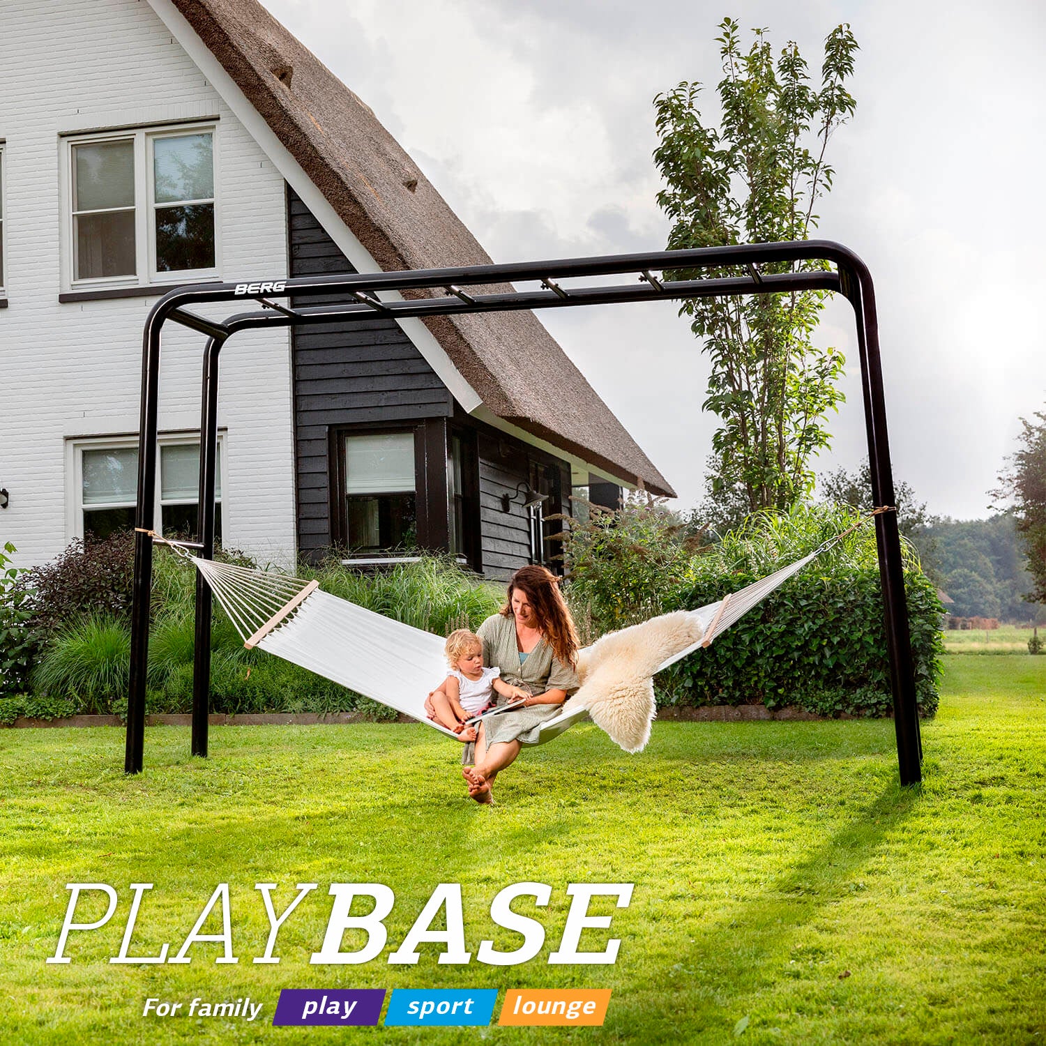BERG PlayBase frame with a hammock seat for relaxing, set up alongside swing and climbing accessories, showing versatility for outdoor backyard fun.