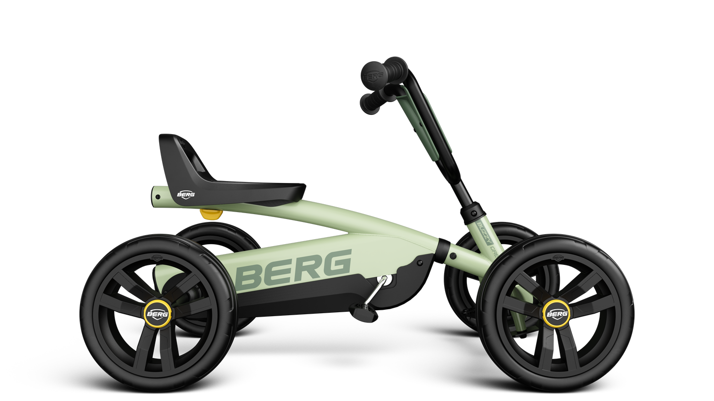 Side angle of the BERG Buzzy Green ride-on go-kart with adjustable steering wheel