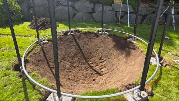 Digging a bowl-shaped pit according to Berg inground trampoline specifications