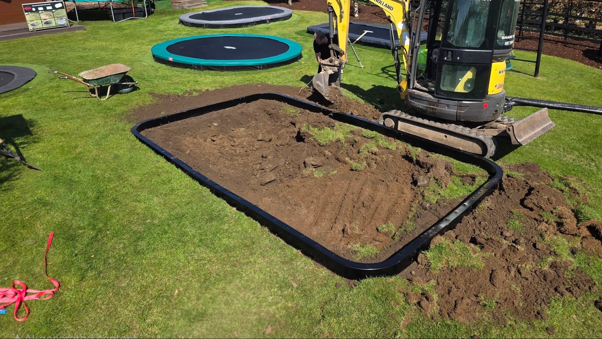 Excavating the bowl-shaped pit required for a rectangular Berg Ultim Champion inground trampoline