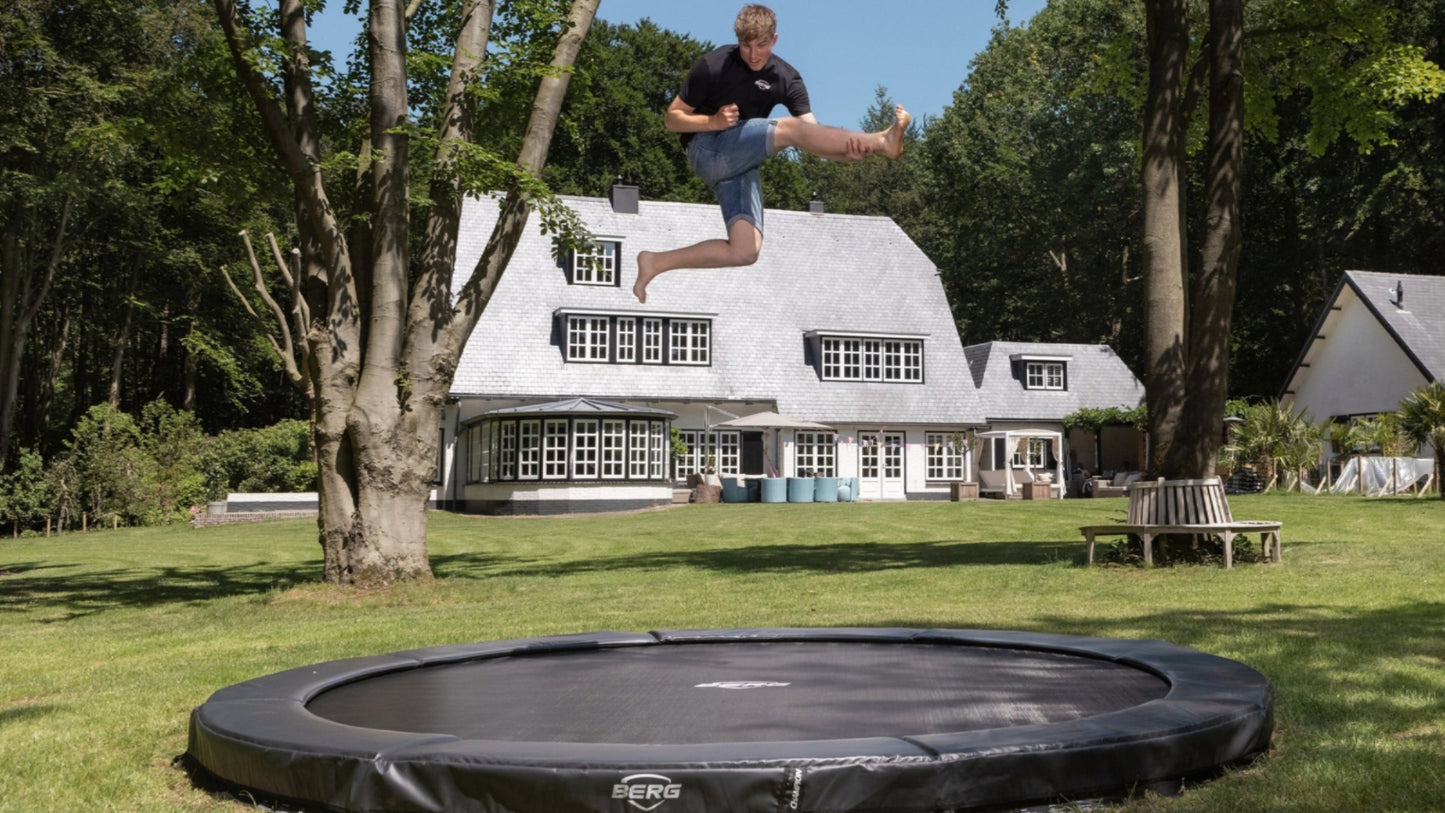 Child jumping on BERG Champion InGround trampoline