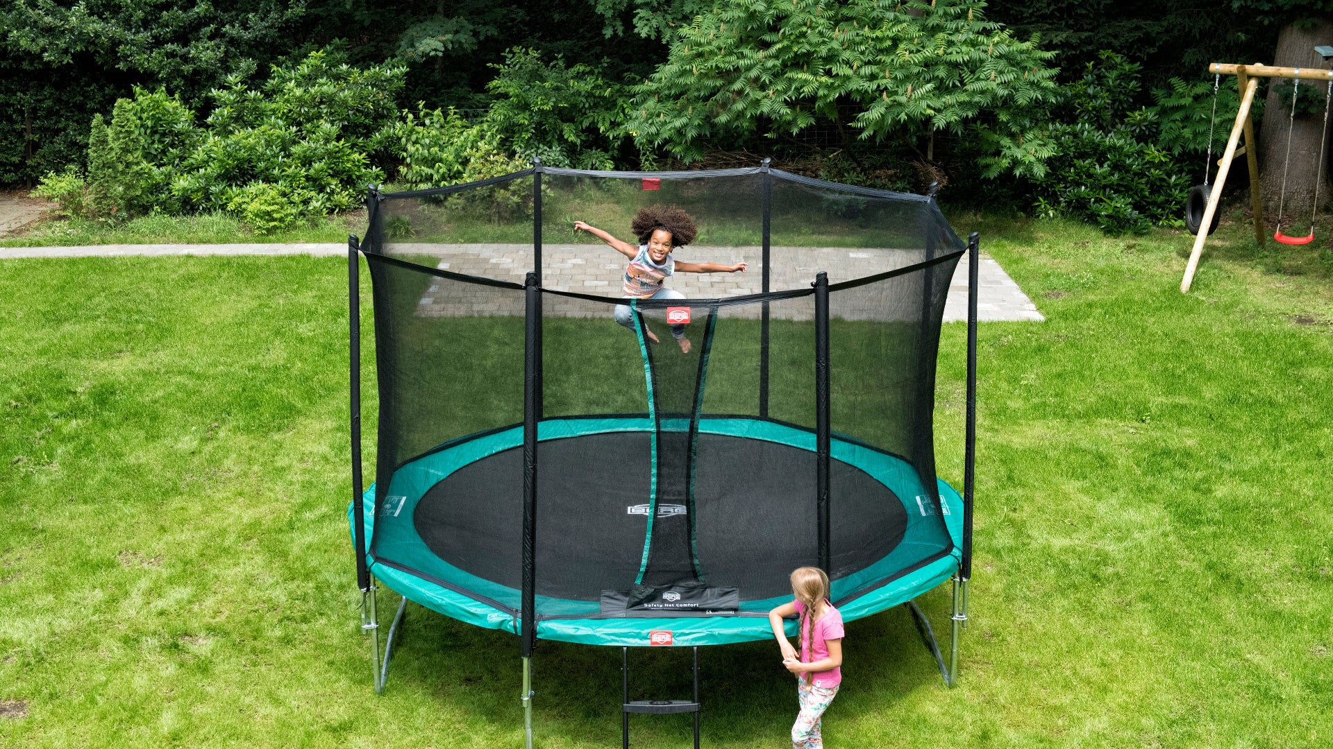 Child jumping on BERG Favorit Regular above-ground trampoline