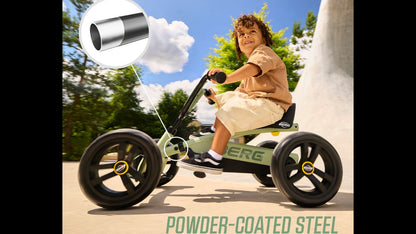 Toddler riding a green BERG Buzzy pedal kart on a garden path